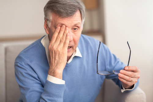 Man rubbing his eye