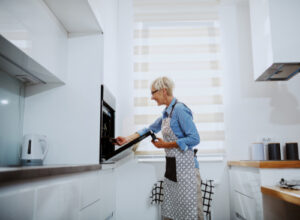 Woman opening oven