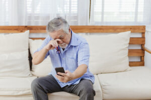 man reading without his glasses on